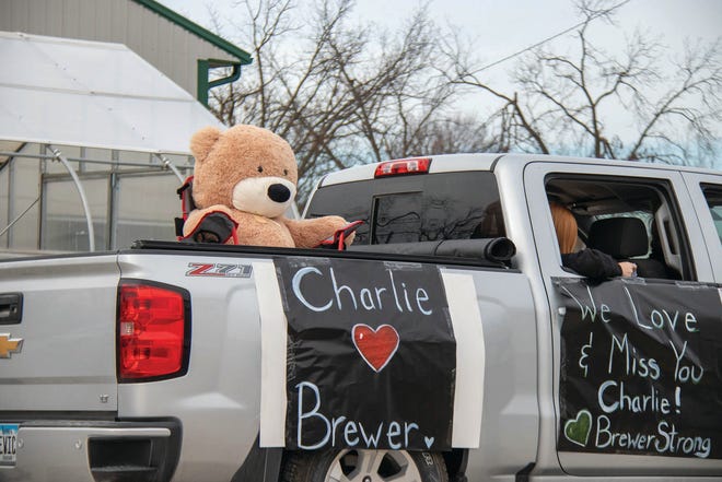 Signs decorate vehicles during a drive-thru visitation on Saturday, Nov. 21 for Charlie Brewer in Woodward.