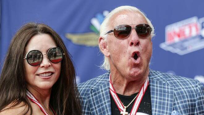 Retired wrestler Nature Boy Ric Flair and former WCW manager Wendy Barlow aka Fifi the Maid, walk the red carpet during the 101st running of the Indy 500 at Indianapolis Motor Speedway on Sunday May 28, 2017.